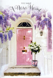 Outside a modest home near Hackney Marshes, this doorway scene feels like a gentle exhale at the end of moving day, captured just as the light softens. Overhead, abundant wisteria trails down in loose, fragrant streams of lavender and pale purple, framing the entrance the way blossom sometimes frames garden gates along the Lea Valley paths in late spring. Beneath that floral canopy, a pink front door glows softly, its muted, chalky tone harmonising with a matching shutter and lending the façade an almost storybook charm. The surrounding walls, painted a clean, slightly weathered white, bounce the afternoon light back onto the flowers and door, creating a quiet, luminous atmosphere. At the threshold, a florist's bucket made of simple grey metal sits solidly on the step, brimming with cushioned white and cream roses. Each bloom feels plush and generously petalled, offset by small sprays of cool green foliage that weave through the arrangement in natural, easy curves. A delicate pink ribbon is tied around the bucket, the tails resting casually against the stone, echoing the tone of the door and giving the flowers the air of a thoughtfully wrapped gift. The mood suggests someone in the Hackney Marshes area has just received same-day delivery to mark picking up their keys - a visual way of saying welcome home without words. The interplay of pastel colours, dappled shadows, and cascading blossoms evokes a sense of fresh beginnings, making the whole scene feel like a quiet promise of comfort, warmth, and future memories within.